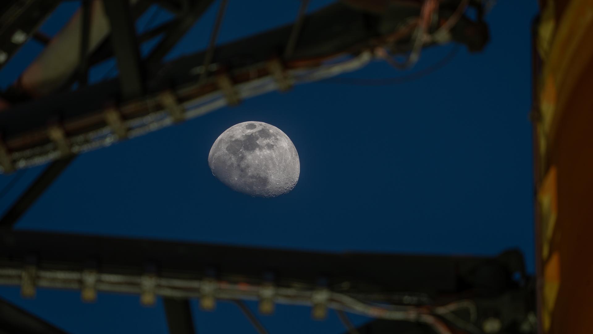 The Moon is seen shining over the SLS (Space Launch System) and Orion spacecraft, atop the mobile launcher on January 28, 2026. The rocket is currently at Launch Pad 39B at NASA’s Kennedy Space Center in Florida, as teams are preparing for a wet dress rehearsal to practice timelines and procedures for the launch of Artemis II.